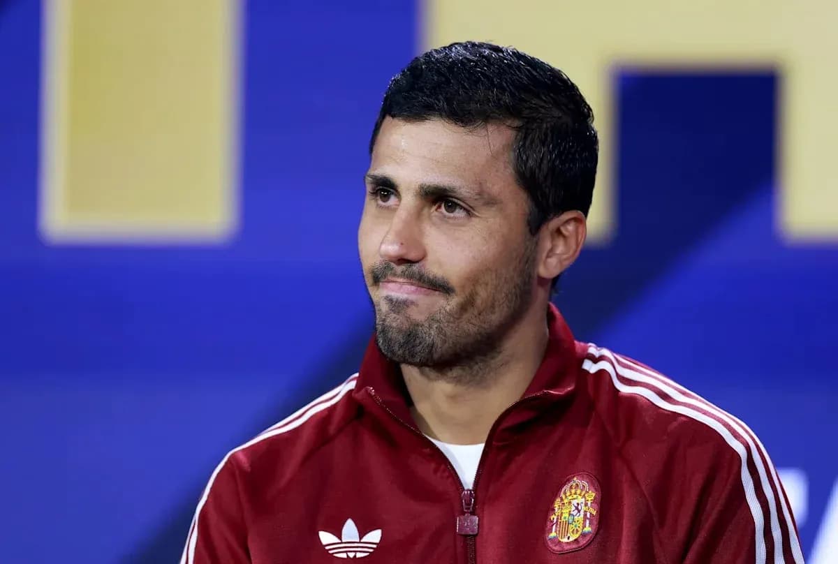 Football player at press conference wearing Spain tracksuit