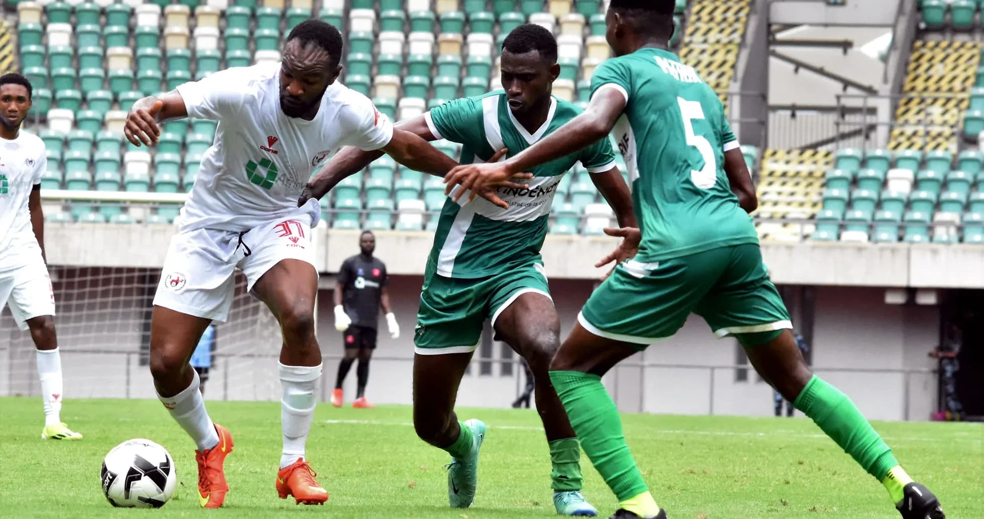 Enugu Rangers player challenged by Katsina United defenders
