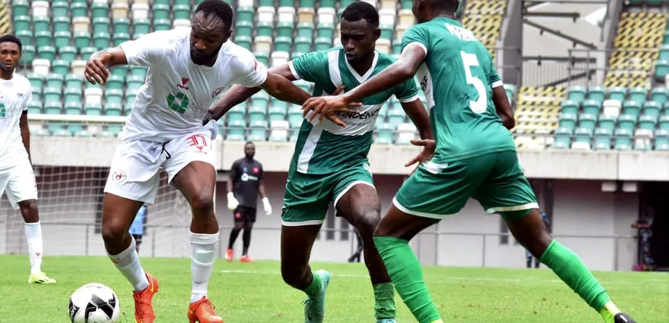 Enugu Rangers player challenged by Katsina United defenders