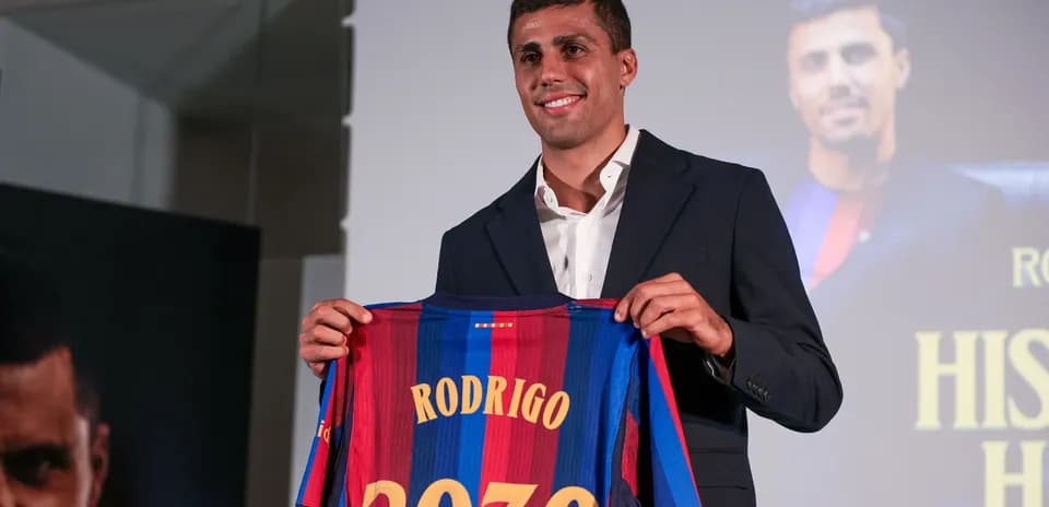 Player holding Barcelona jersey with 'Rodrigo 2030'