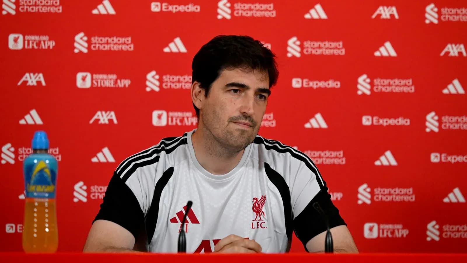 Coach at press conference with Liverpool branding