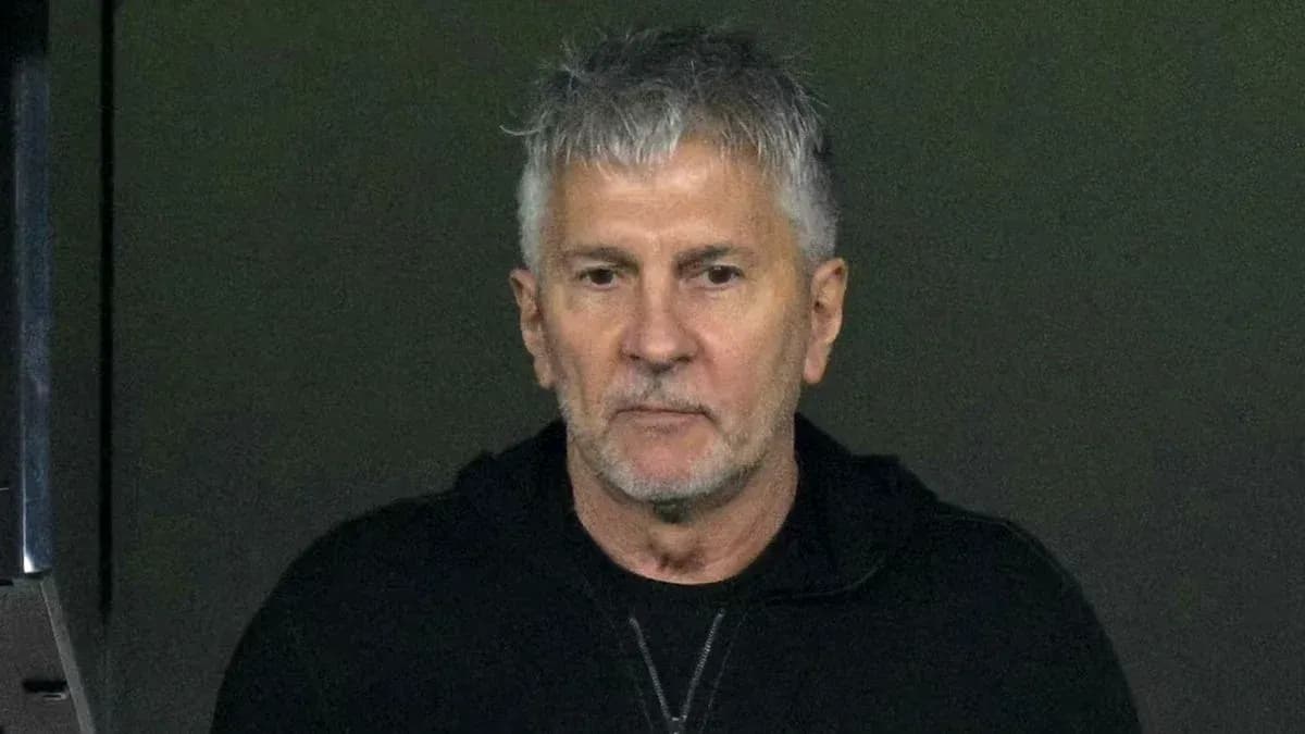 Man in black jacket observing from a distance