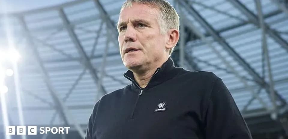 Coach standing in stadium before match