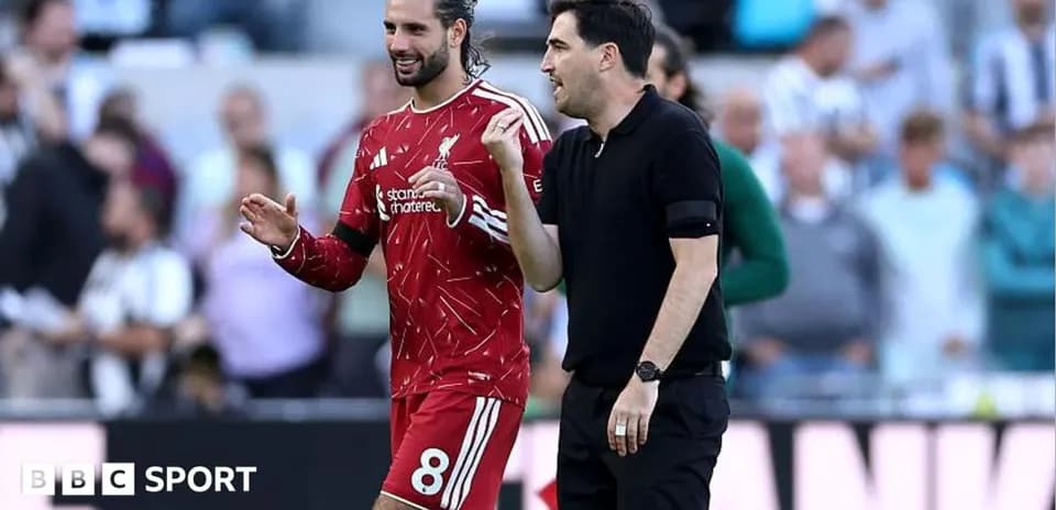 Player and coach discussing during match at stadium