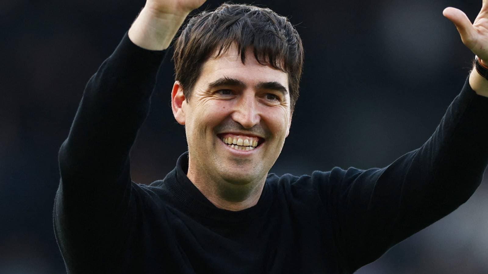 Coach celebrating with raised hands after match