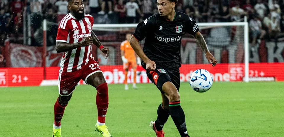 Player dribbling the ball during NEC vs Olympiakos