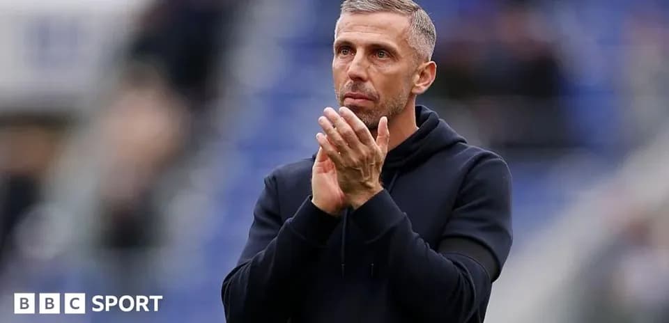 Coach applauding during a match at the stadium