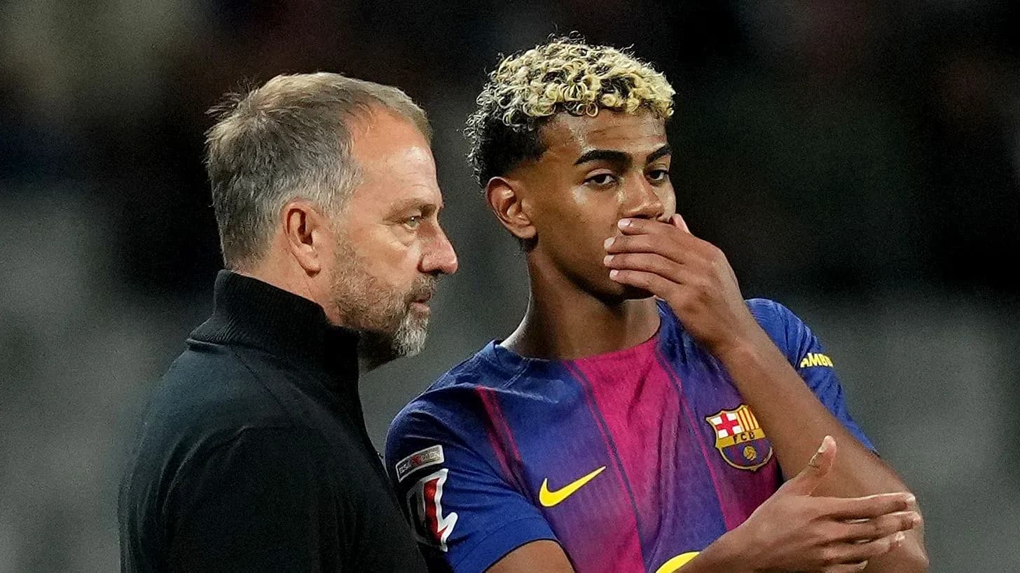 Coach discussing strategy with Barcelona player during match