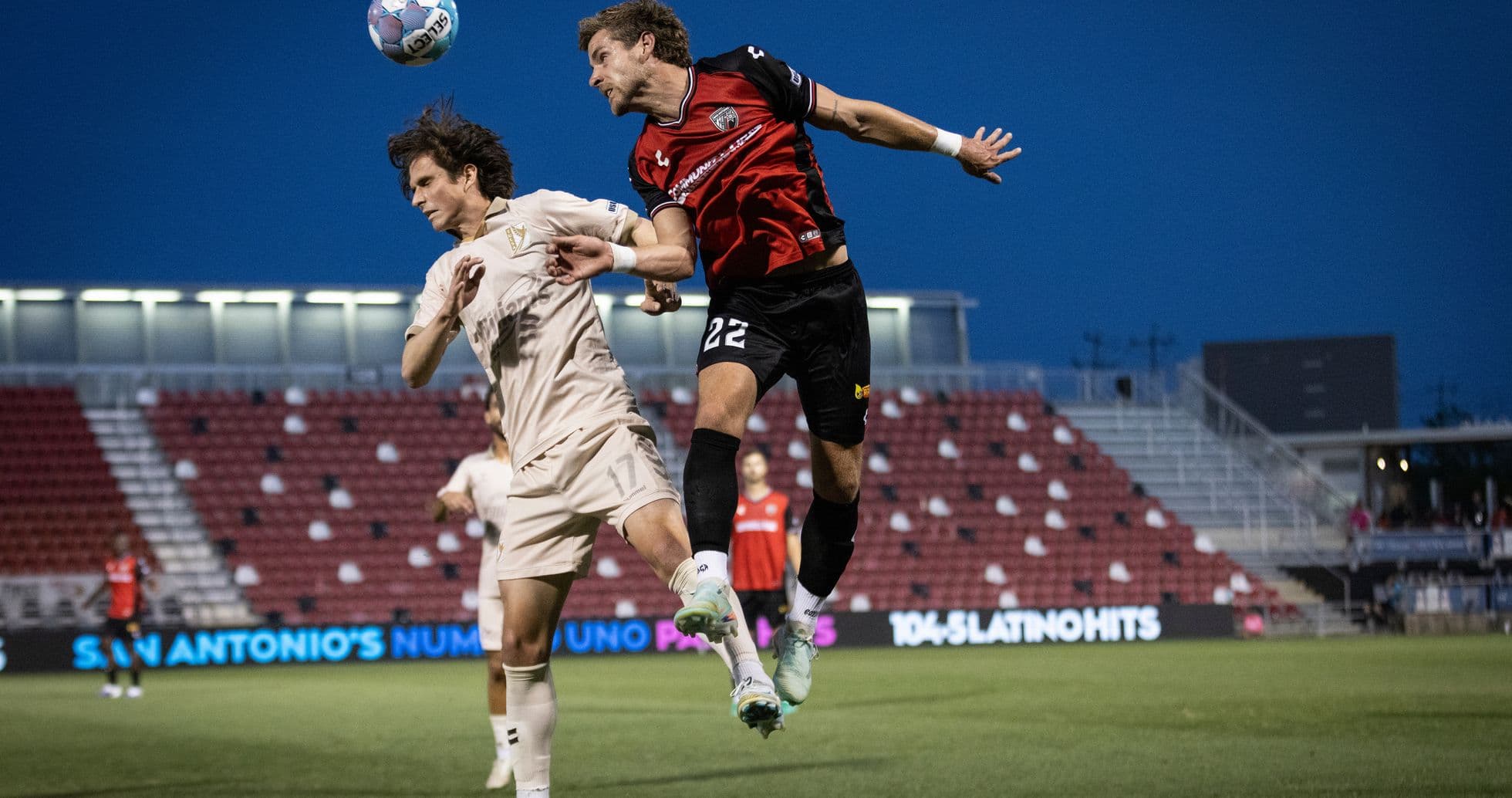 Players contesting a header during FC Tulsa match