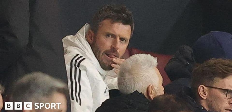 Man in white jacket seated in audience