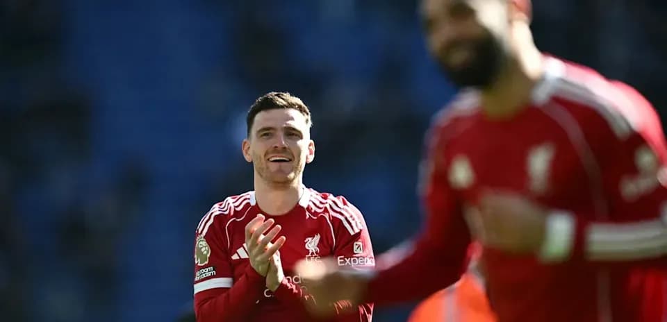 Two Liverpool players celebrating on the pitch