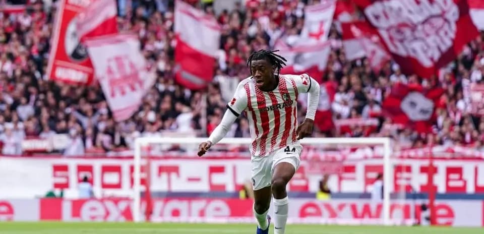 Player dribbling the ball in front of fans