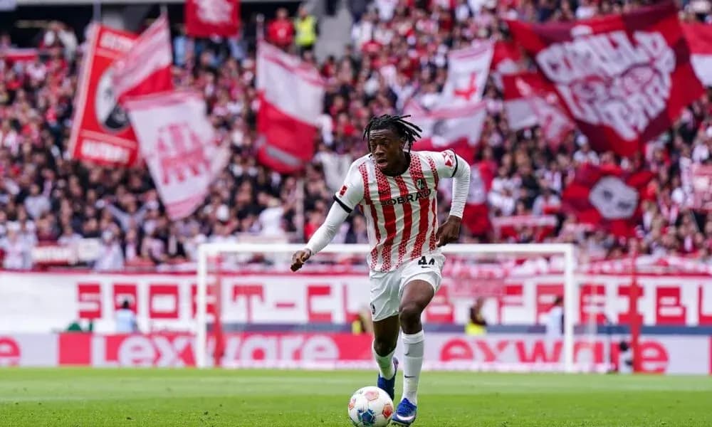 Player dribbling the ball in front of fans