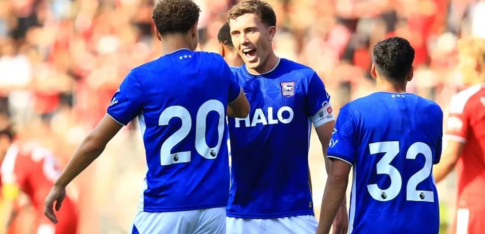 Players celebrating in blue jerseys during match