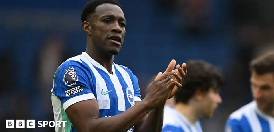 Player applauding fans while wearing Brighton kit