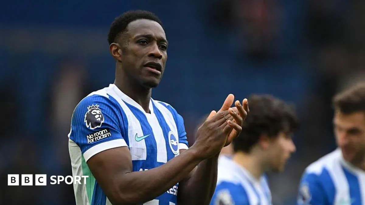 Player applauding fans while wearing Brighton kit