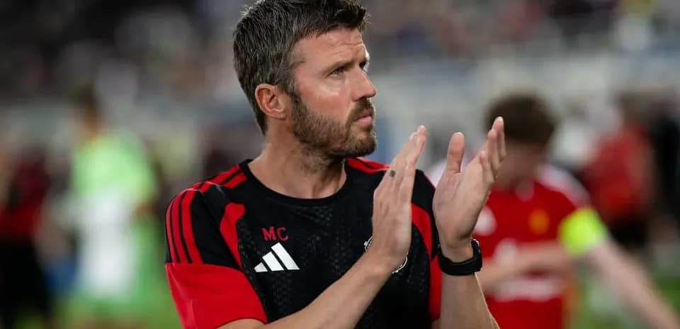 Coach clapping during team warm-up on field