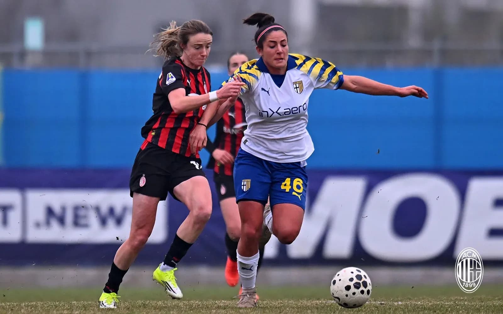 AC Milan W player challenges Parma W player for ball