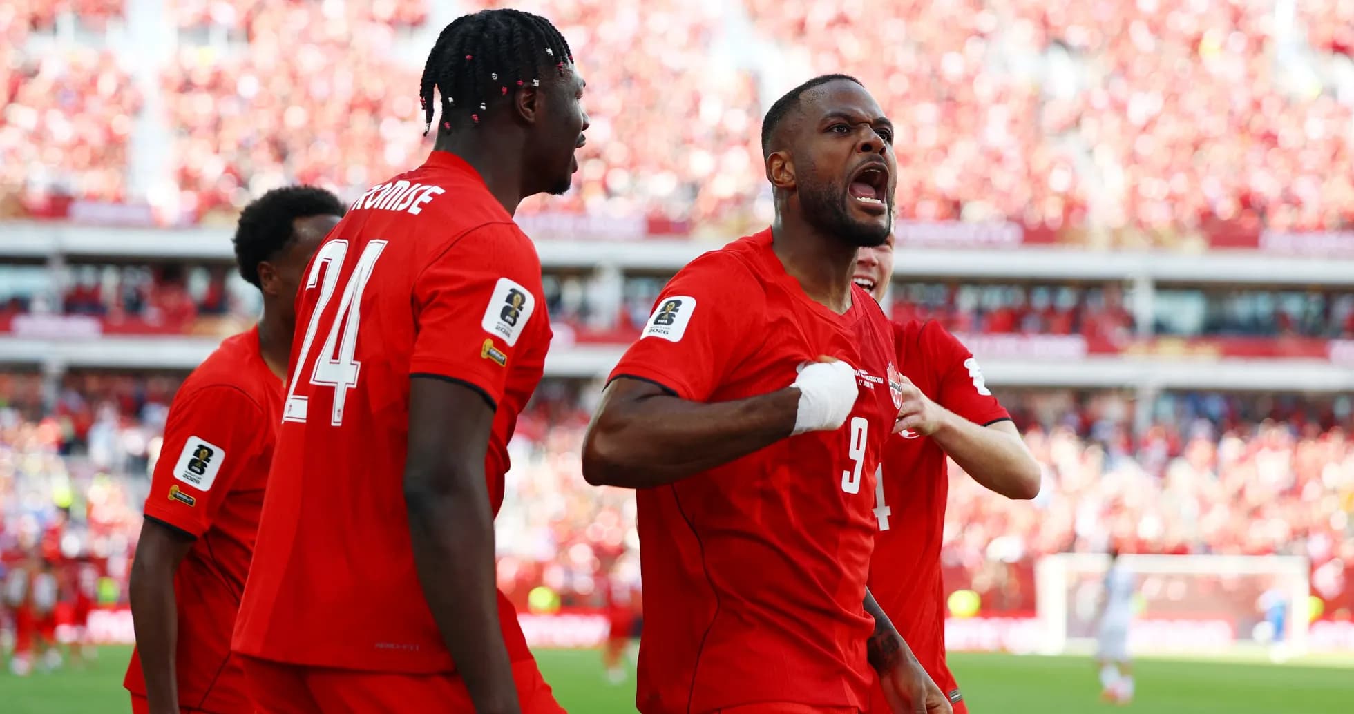 Canada players celebrating a goal in World Cup match