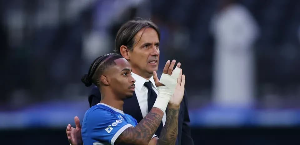 Player and coach interacting on the field post-match
