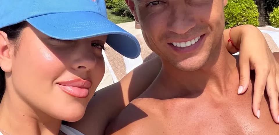 Couple posing for a selfie in sunny outdoor setting