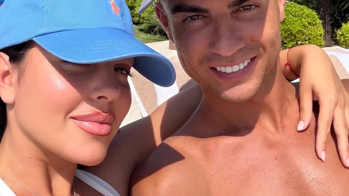 Couple posing for a selfie in sunny outdoor setting