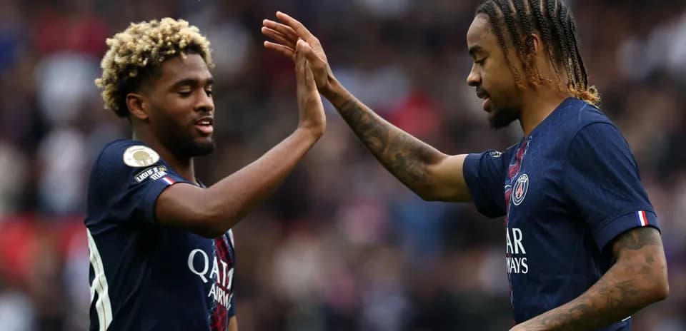 Two PSG players celebrating with a high-five