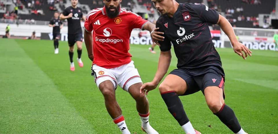 Two players competing for the ball on the pitch