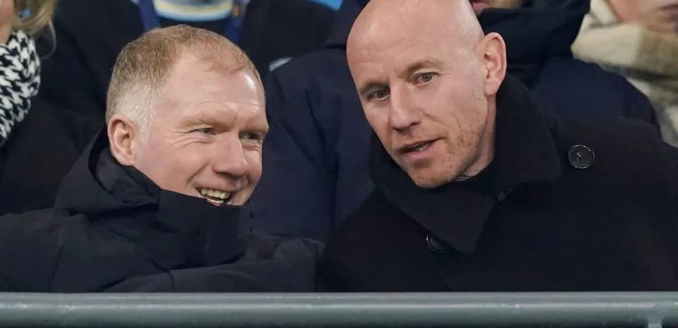 Two men chatting in stadium seats during event
