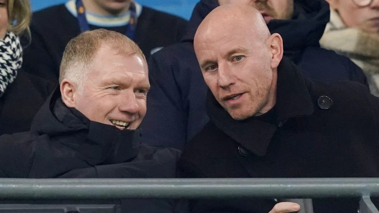 Two men chatting in stadium seats during event