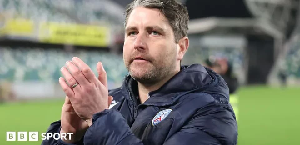 Coach clapping to fans after the match