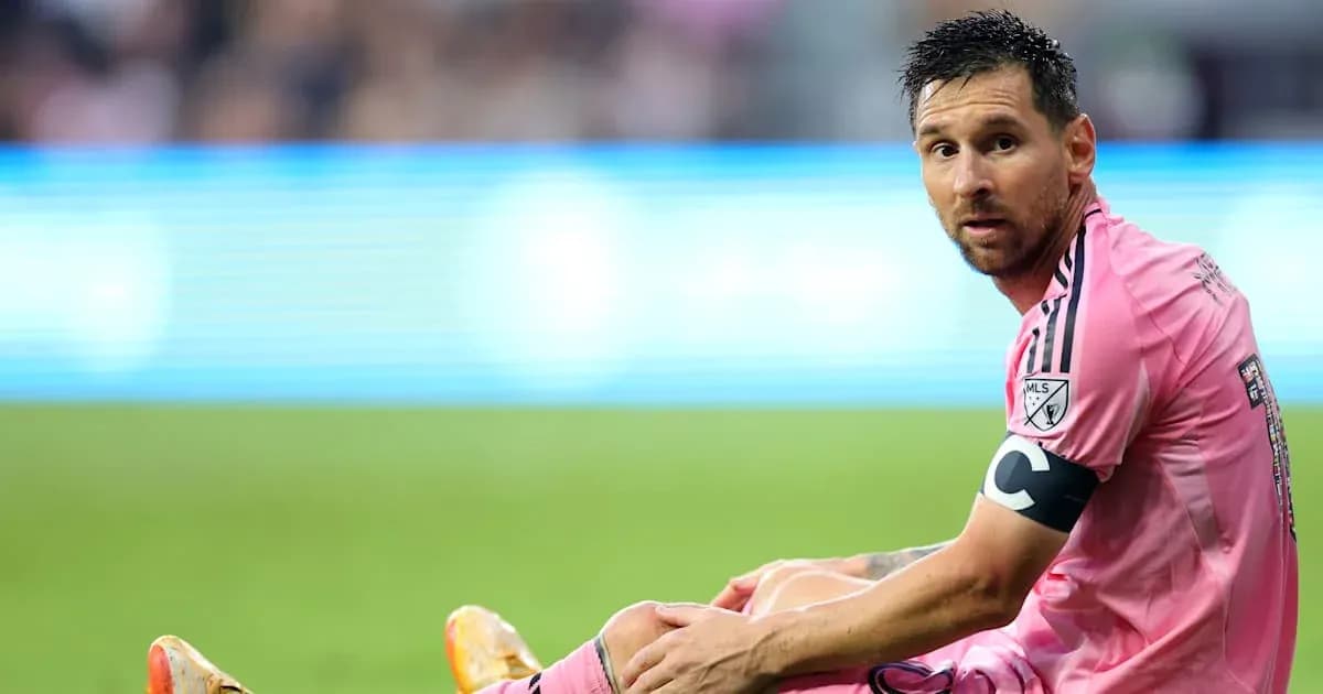 Player sitting on field during match in pink jersey
