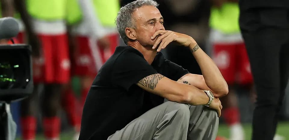 Coach sitting pensively during a match