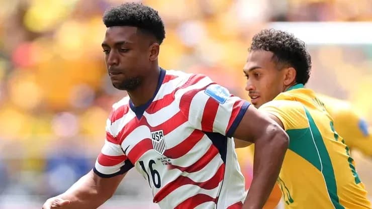 Player in USA kit running with ball during match