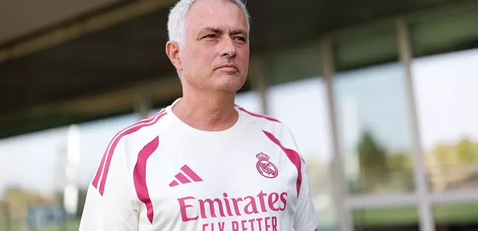 Coach wearing Real Madrid kit at training facility