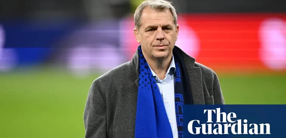 Man in a coat and scarf on the field