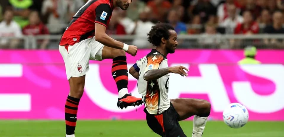 AC Milan player kicking ball against Venezia player