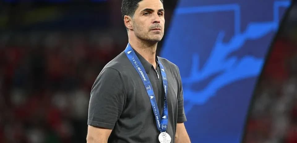 Coach wearing a silver medal at final event