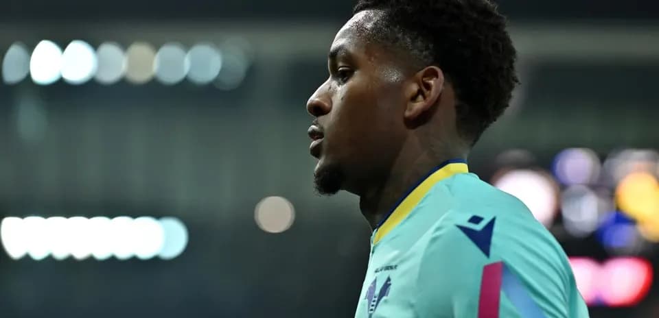 Player in teal kit during match warm-up