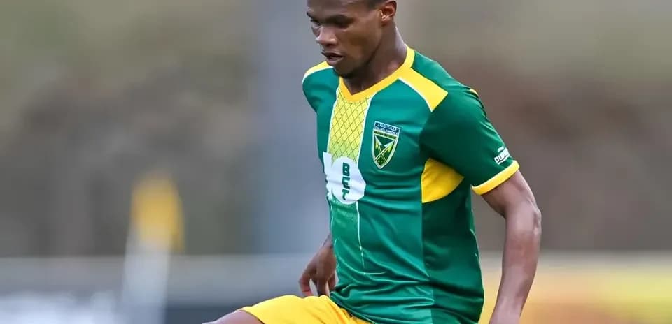 Player in green and yellow jersey during match