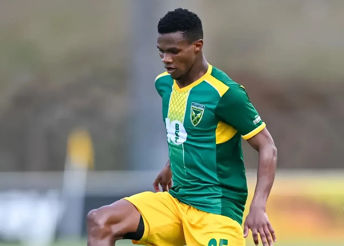 Player in green and yellow jersey during match