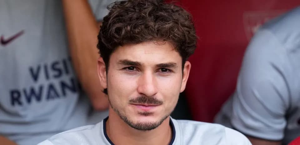 Player seated on bench during match preparation