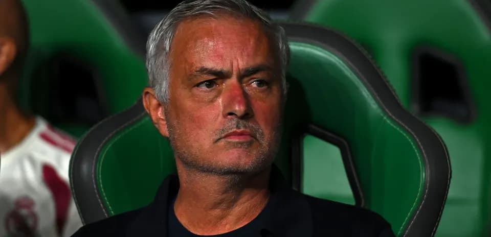 Coach sitting on bench during match