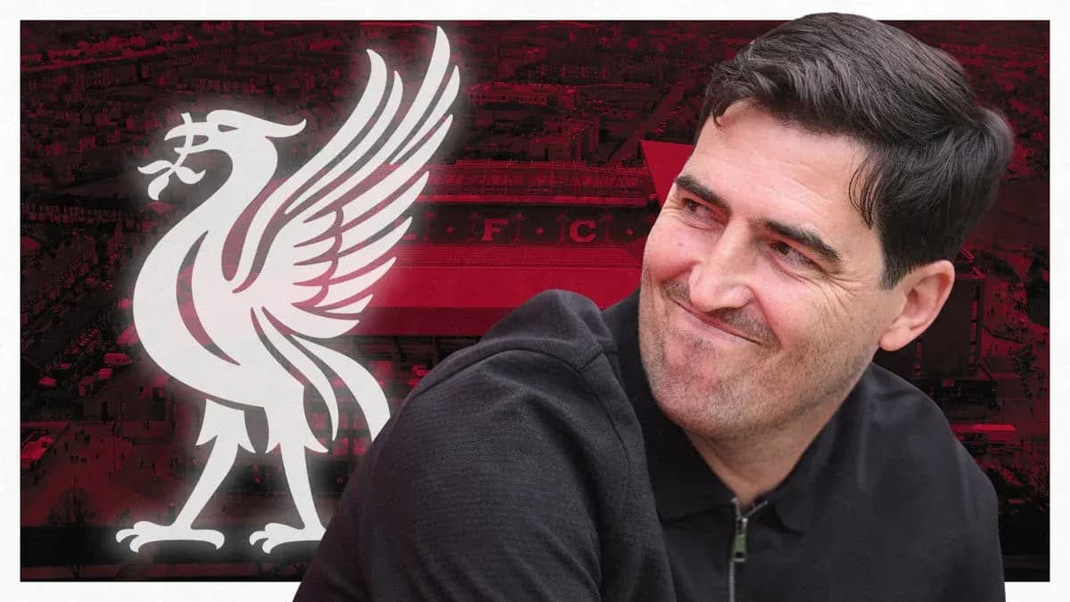 Man smiling in front of Liverpool FC logo