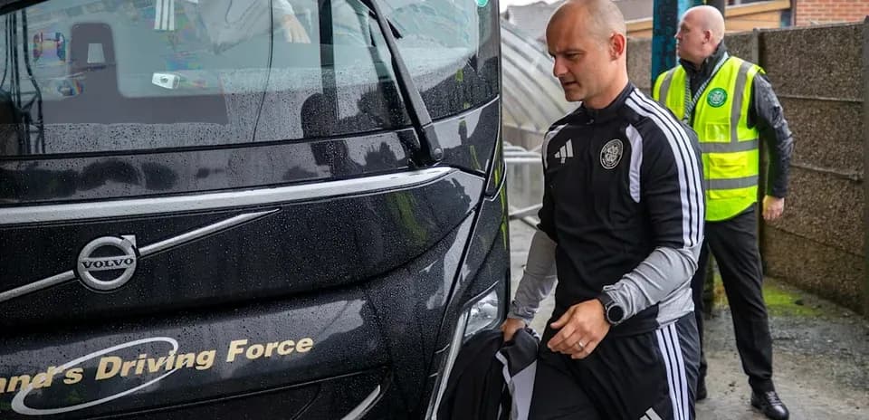 Coach arriving at venue with staff members