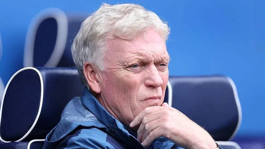 Manager seated on bench during match