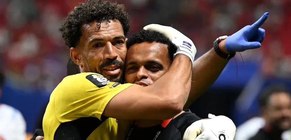 Goalkeeper and coach embracing after match victory