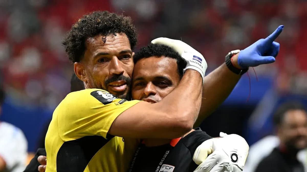 Goalkeeper and coach embracing after match victory