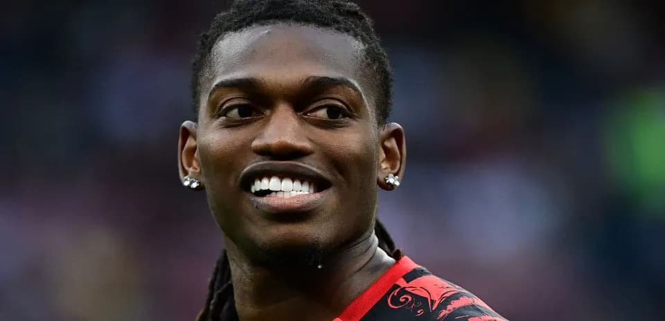 Player smiling in a red and black jersey