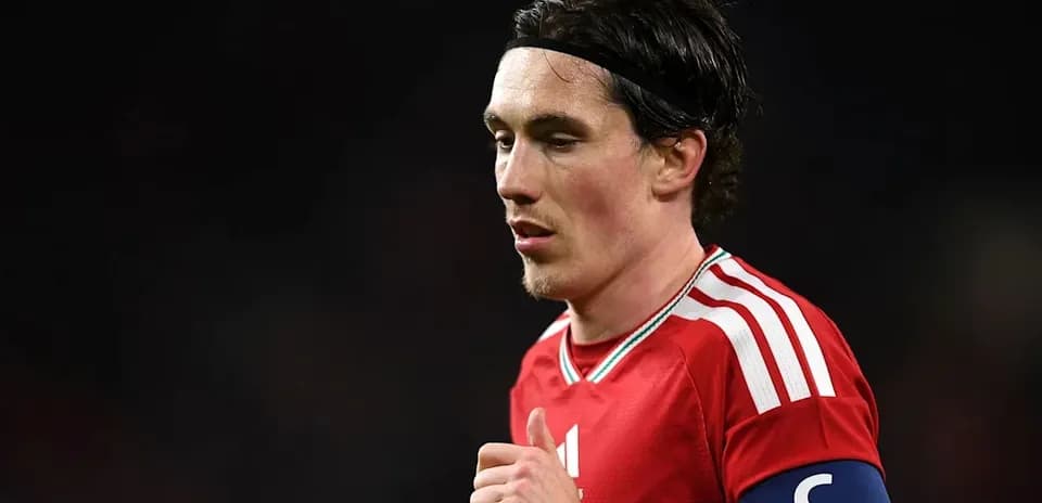 Player wearing red jersey with captain's armband